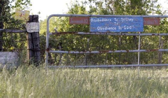 Handmade signs are fixed to John Joe Gray's property near Trinidad, Texas, on April 9.